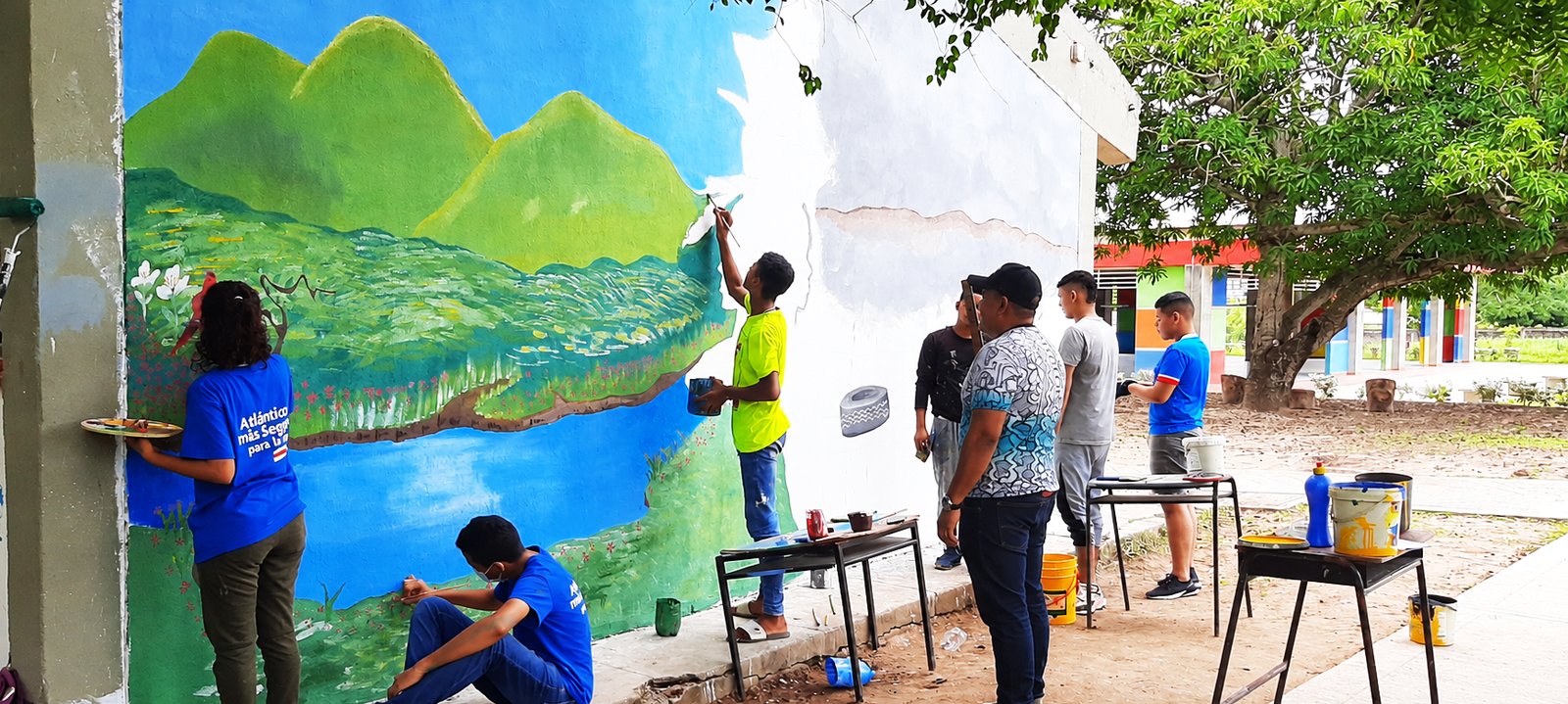Estudiantes creando un mural artístico